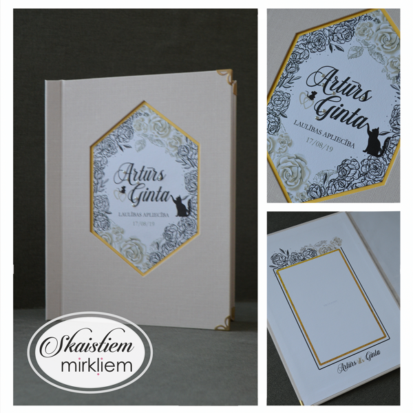 Gaiši rozā laulības apliecības vāki ar sešstūra rāmi, ziediem un vārdiem "Artūrs un Ginta"