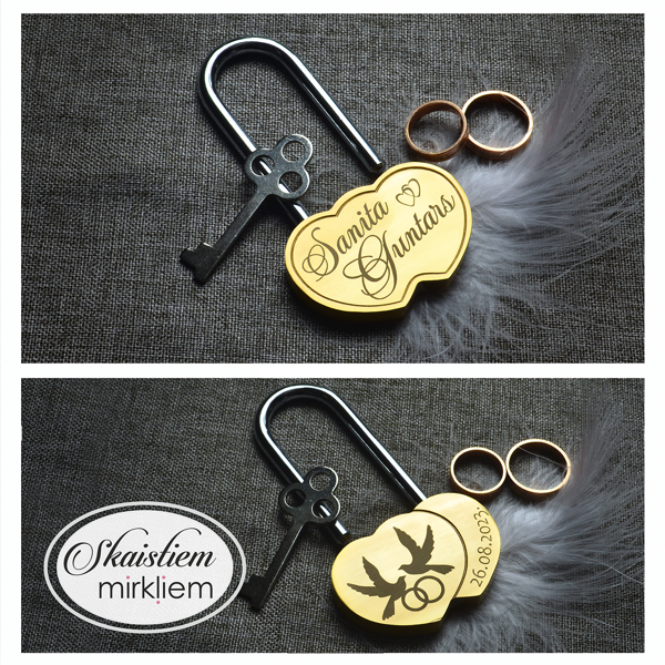 Gravēta sirds formas slēdzene Sanita un Guntars ar dūju zīmējumu un datumu