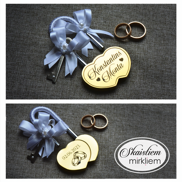 Gravēta sirds formas slēdzene "Konstantīns un Monta" ar gredzenu simbolu un baltu lentīti