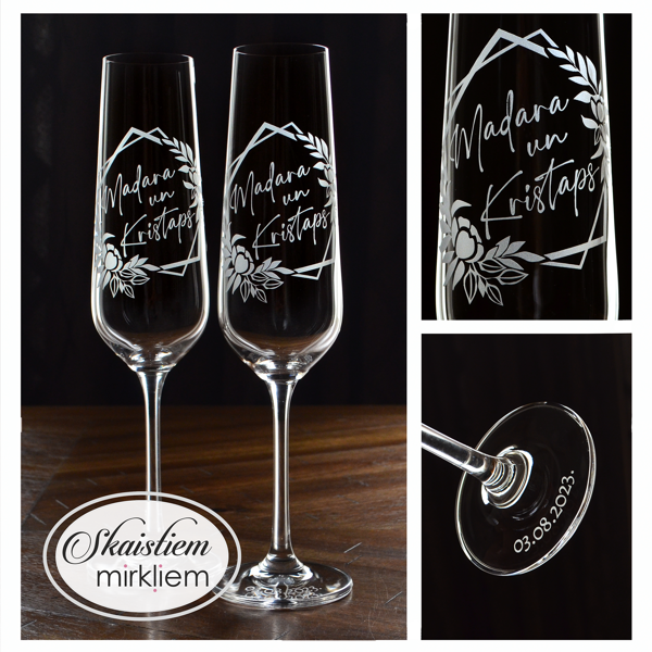 Kāzu glāzes Madarai un Kristapam, kur vārdi ietverti rombveida lapu, ziedu rāmī