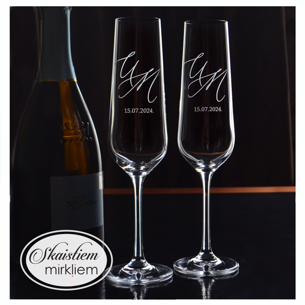 Elegants gravējums ar iniciāļiem U un N un kāzu datumu tīrā, modernā stilā