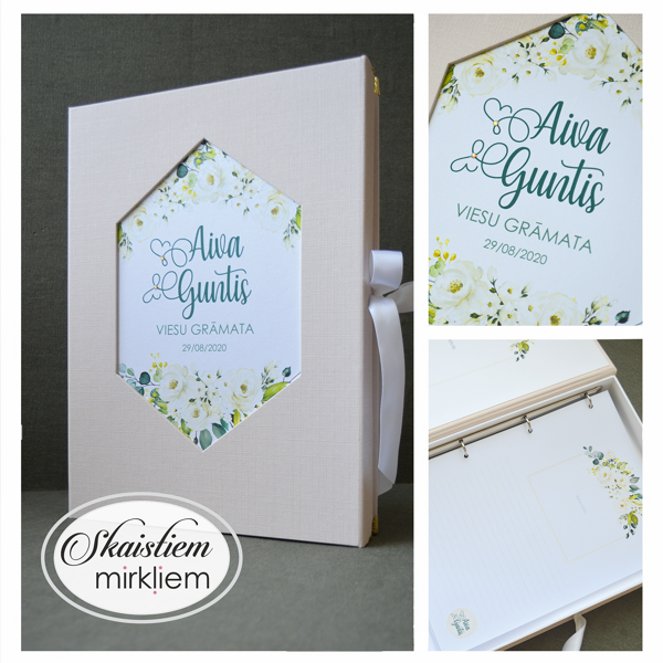 Gaiši rozā viesu grāmata ar baltu ziedu printu, zaļumiem un pieskaņotām lapām